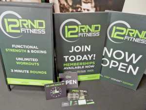 Branded tabletop signs on display at event with seating information