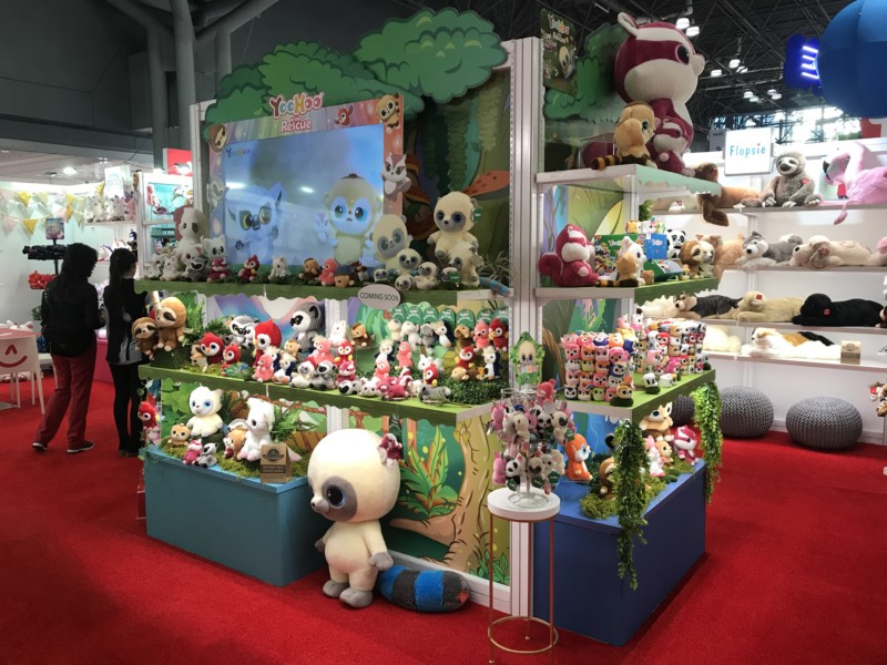 A vibrant trade show booth showcasing eye-catching graphics, banners, and product displays, attracting visitors at a busy event.