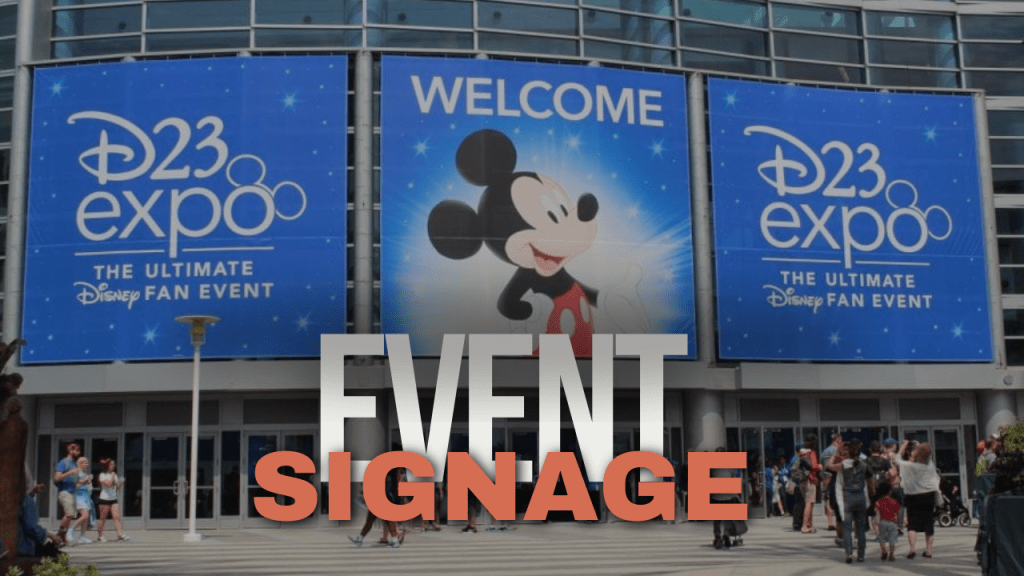 Colorful Disney fan event expo signage outside entrance with attendees entering.
