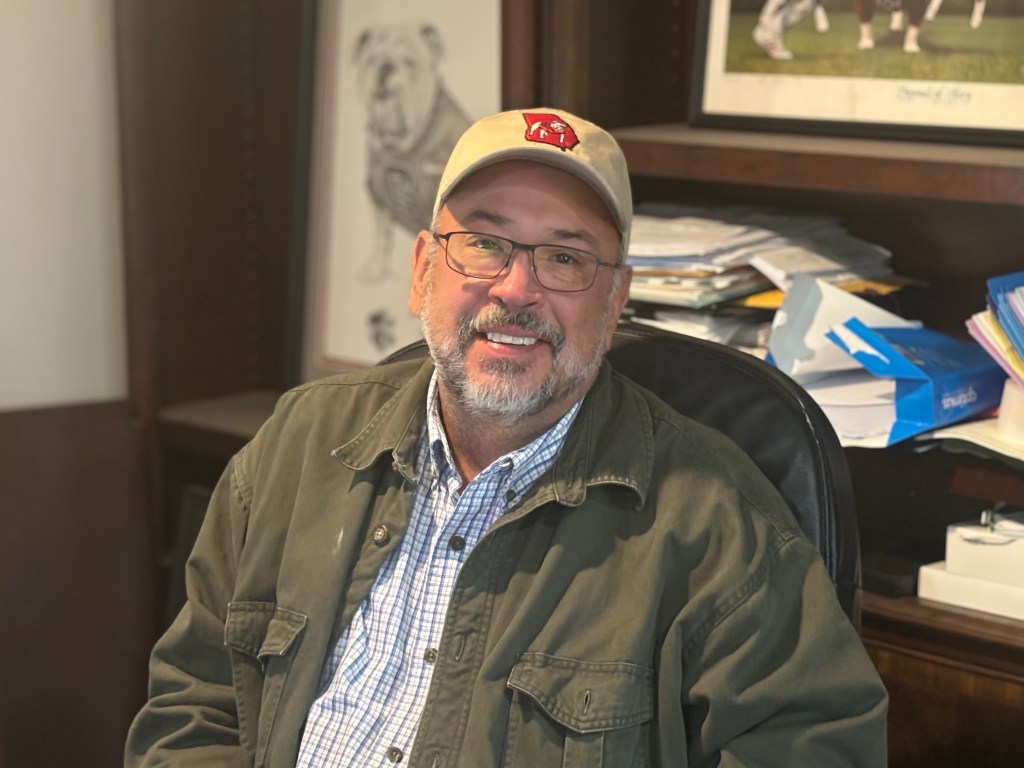 Mark Watson, president of VistaCraft, smiling confidently in the office setting.