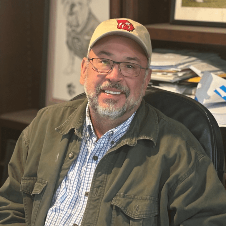 Mark Watson, president of VistaCraft, smiling confidently in the office setting.