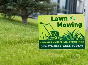 A vibrant yard sign displaying a clear message in bold lettering, placed on a grassy lawn.