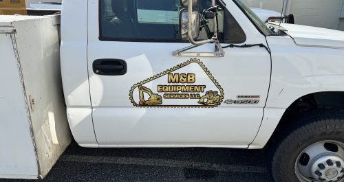 A vibrant business logo decal applied to the side of a car, showcasing clear branding in an outdoor setting.