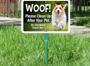 A vibrant yard sign displaying a clear message in bold lettering, placed on a grassy lawn.